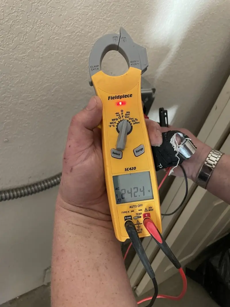 Voltage testing with clamp meter during Ceiling Fan Installation in New Roads